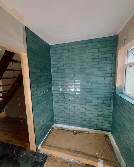 Teal metro tiles in a new shower room