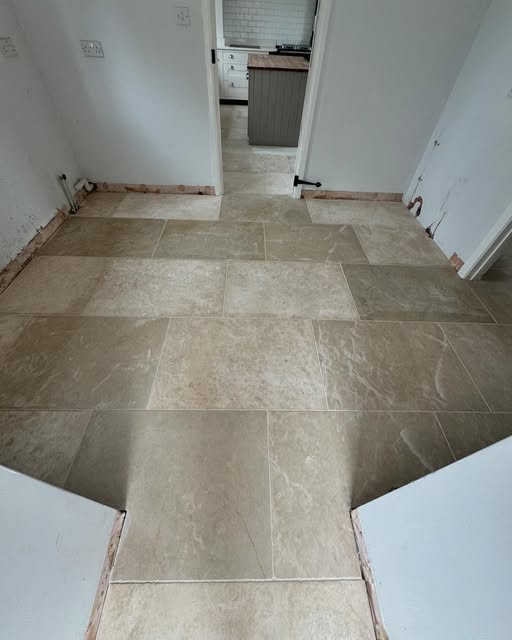 Stone effect floor tiles running through to the kitchen
